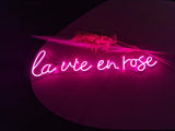 La Vie En Rose Rose Purple Colored Neon Sign. Goes perfectly for a high end wedding as a venue decoration and also a talking point for guests and great for instagram or facebook photos. Romantic Neon Sign.